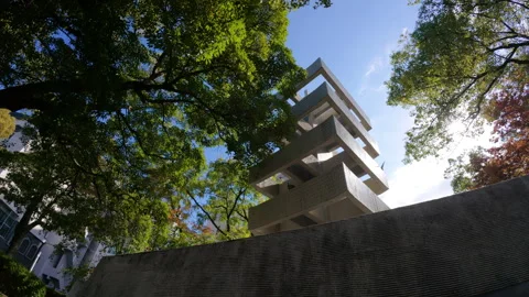 Hiroshima Peace Memorial Tower among green trees and blue sky Stock Footage 335533599
