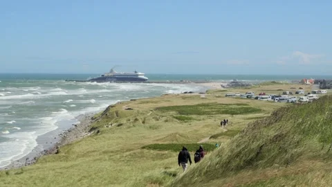 Hirthals, Denmark - July 06, 2026: Couple hiking on a windy coastal path Stock-Footage 338329097