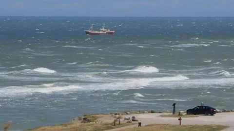 Hirthals, Denmark - July 06, 2026: Fishing trawler navigating rough ocean waves Stock Footage 338329504