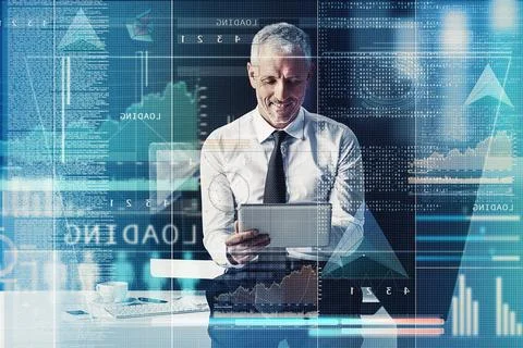 His code is coming along nicely. a mature businessman working on programming 스톡 사진