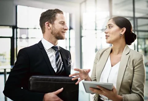 His constructive criticism is always helpful. Cropped shot of two businesspeo Stock Photos