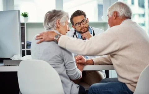 His duty and commitment is to care. a senior man consoling his wife during a Stock Photos