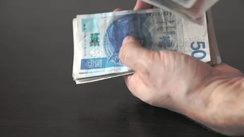 In his hands, the man counts Polish fifty zloty bills. Vídeo Stock 194733019