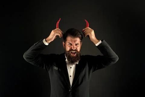 His true essence. he is devil in business. businessman has red pepper horn 写真素材
