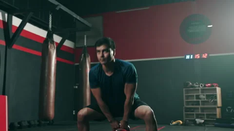 Hispanic athlete lifting kettlebell training in the gym Stock Footage 151600272