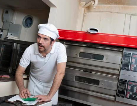 Hispanic baker working in commercial kitchen Stock Photos