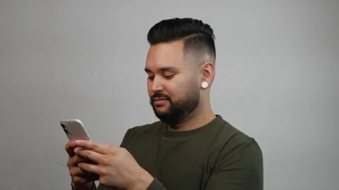 Hispanic Bearded Man Texting on Mobile Phone Stock Footage 173347000