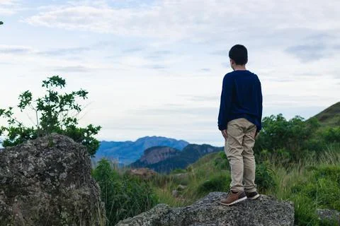 Hispanic boy from back looking at the landscape Stock Photos