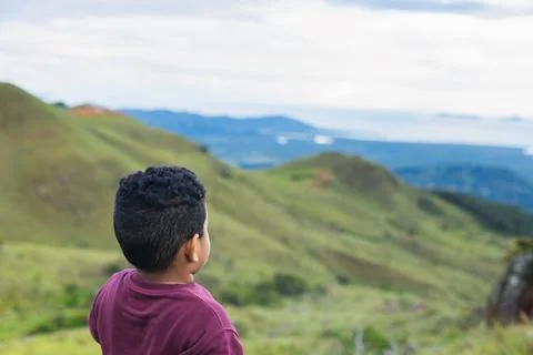 Hispanic boy from back looking at the landscape Stock Photos