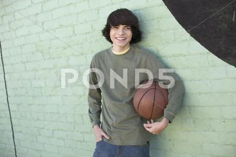 Hispanic boy holding basketball Stock Photos