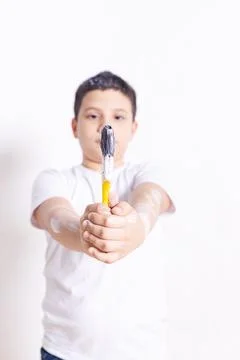 Hispanic boy holds the paintbrush very serious Stock Photos