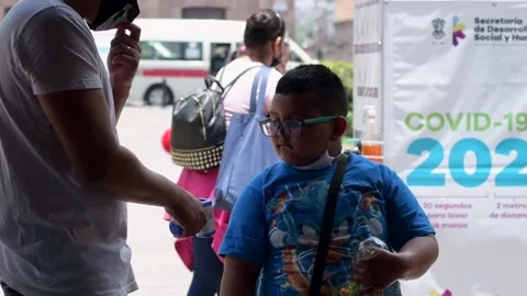 Hispanic boy with mask getting covid 19 temperature test in Morelia Mexico Stock Footage 134993457