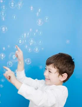 Hispanic boy popping bubbles Stock Photos