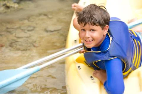 Hispanic boy sitting in canoe Stock Photos