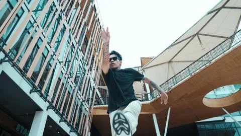 Hispanic break dancer dance at camera with low angle camera. Mall. Endeavor. 写真素材