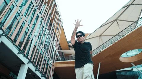 Hispanic break dancer dance at camera with low angle camera. Mall. Endeavor. 写真素材