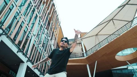 Hispanic break dancer dance at camera with low angle camera. Mall. Endeavor. 스톡 사진