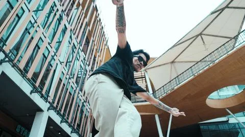 Hispanic break dancer dance at camera with low angle camera. Mall. Endeavor. 스톡 사진