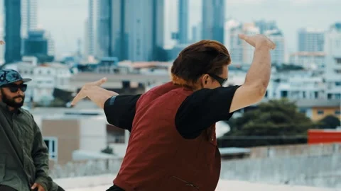 Hispanic break dancer practice B boy dance with friends at roof top. hiphop. Stock Footage 258026665