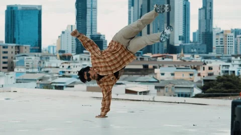 Hispanic break dancer practice B-boy footsteps at roof top with city. hiphop. Stock Footage 258478880
