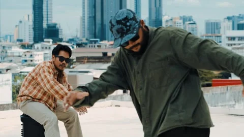 Hispanic break dancer practice B boy dance with friends at roof top. hiphop. Stock Footage 263485078