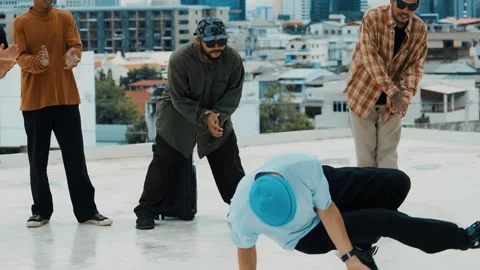 Hispanic break dancer practice B boy dance with friends at roof top. hiphop. Stock Footage 263714597