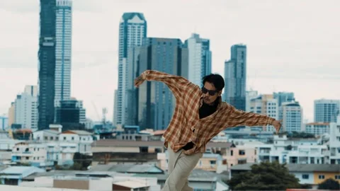 Hispanic break dancer practice B-boy footsteps at roof top with city. hiphop. Stock Footage 264483230