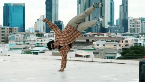 Hispanic break dancer practice B-boy footsteps at roof top with city. hiphop. Stock Footage 269416210