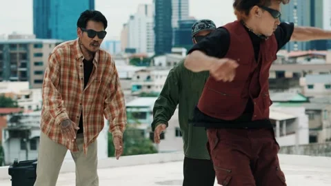 Hispanic break dancer practice B boy dance with friends at roof top. hiphop. Stock Footage 270378884
