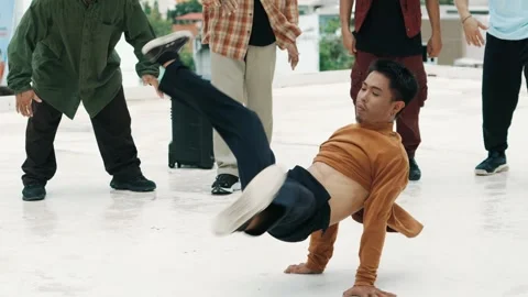 Hispanic break dancer practice B boy dance with friends at roof top. hiphop. Stock Footage 270378948