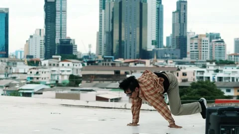 Hispanic break dancer practice B-boy footsteps at roof top with city. hiphop. Stock Footage 270433706