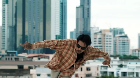 Hispanic break dancer practice B-boy footsteps at roof top with city. hiphop. Stock Footage 271375023
