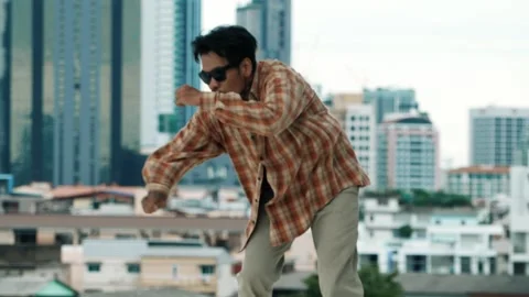 Hispanic break dancer practice B-boy footsteps at roof top with city. hiphop. Stock Footage 272988561