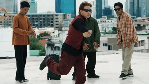 Hispanic break dancer practice B boy dance with friends at roof top. hiphop. Stock Footage 273463596
