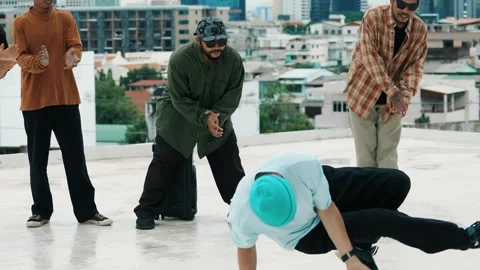 Hispanic break dancer practice B boy dance with friends at roof top. hiphop. Stock Footage 274251794