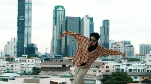 Hispanic break dancer practice B-boy footsteps at roof top with city. hiphop. Stock Footage 274453140