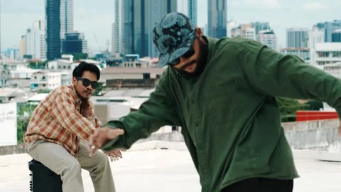 Hispanic break dancer practice B boy dance with friends at roof top. hiphop. Stock Footage 274526991