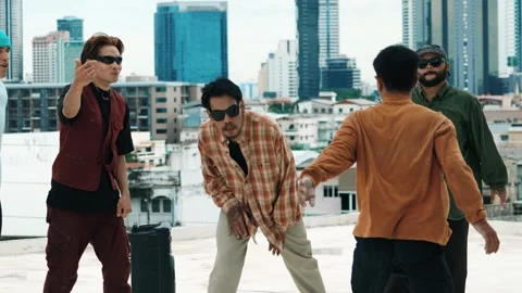 Hispanic break dancer practice B boy dance with friends at roof top. hiphop. Stock Footage 274592616