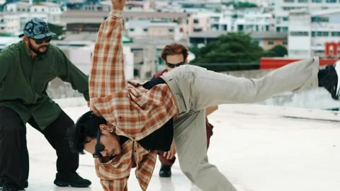 Hispanic break dancer practice B boy dance with friends at roof top. hiphop. Stock Footage 274744018
