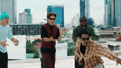 Hispanic break dancer practice B boy dance with friends at roof top. hiphop. Stock Footage 274842900