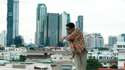 Hispanic break dancer practice B-boy footsteps at roof top with city. hiphop. Stock-Footage 275483378