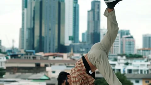 Hispanic break dancer practice B-boy footsteps at roof top with city. hiphop. Stock-Footage 277178413