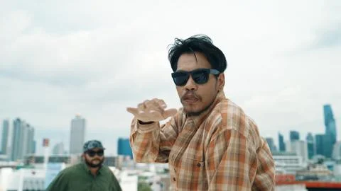 Hispanic break dancer practice B boy dance with friends at roof top. Endeavor. 写真素材