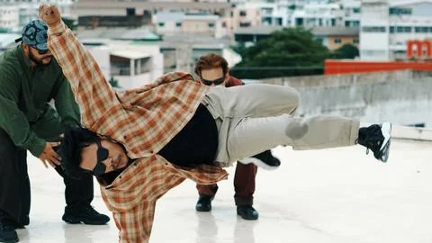 Hispanic break dancer practice B-boy dance with friends at roof top. Endeavor. 写真素材