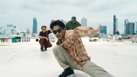 Hispanic break dancer practice B boy dance with friends at roof top. Endeavor. 写真素材