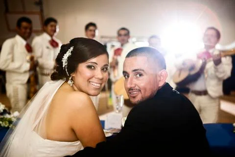 Hispanic bride and groom at wedding reception Stock Photos