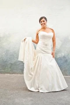 Hispanic bride in wedding dress Stock Photos