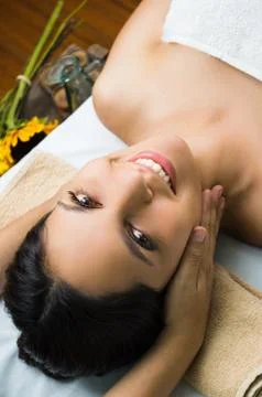 Hispanic brunette model getting massage spa treatment, hands around womans head Stock-Fotos