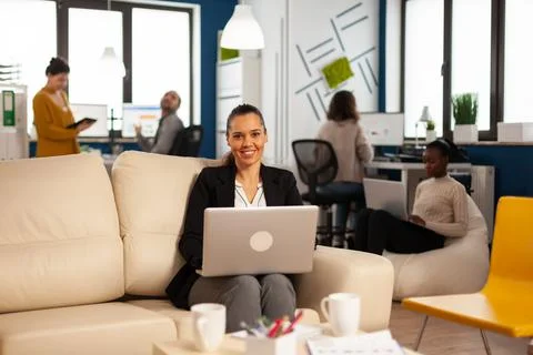 Hispanic business woman smiling at camera holding laptop Stock Photos