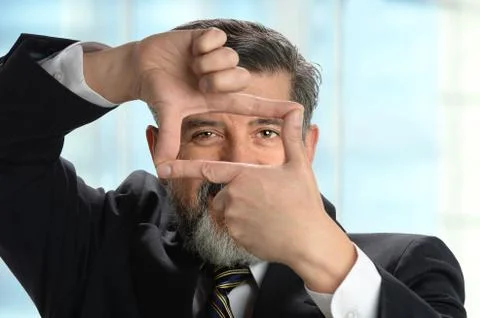 Hispanic Businessman Creating Frame with Hands Stock Photos